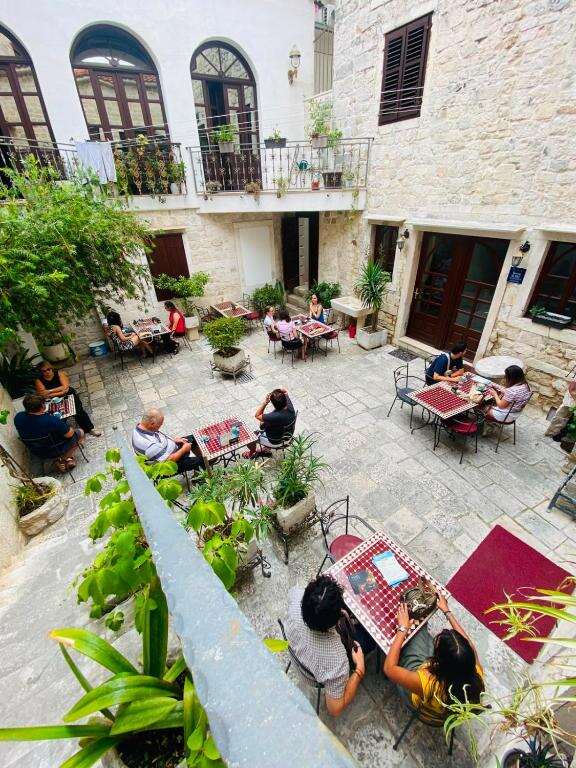 Stone courtyard with tables at Palace Derossi
